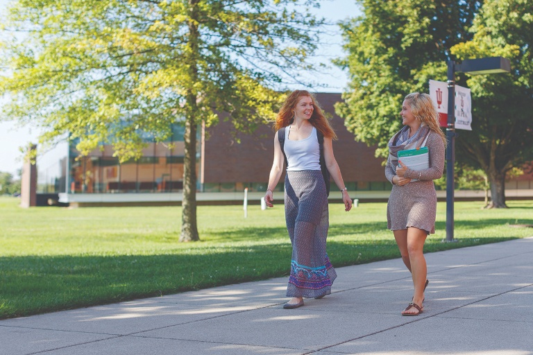 Photo of two girls walking on campus.